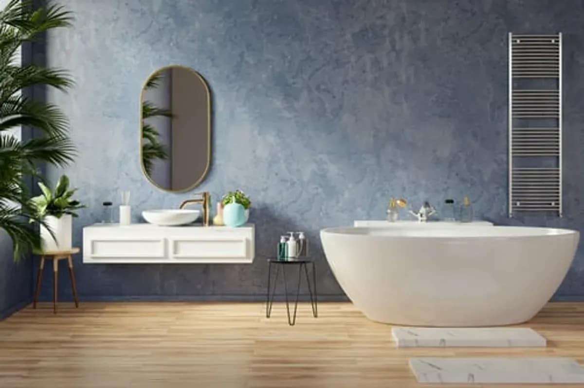 Remodeled bathroom with a freestanding tub and tiled wall