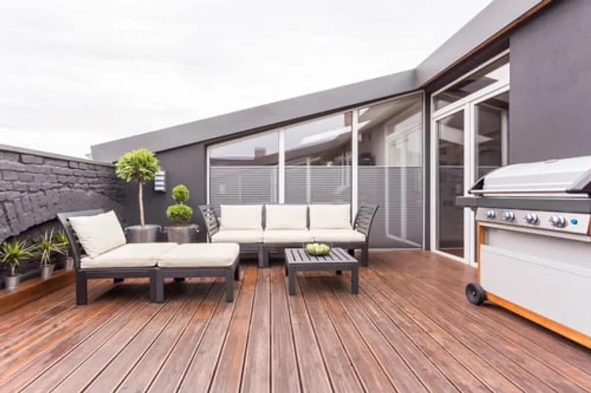 Finished composite deck with lounge seating and a grill