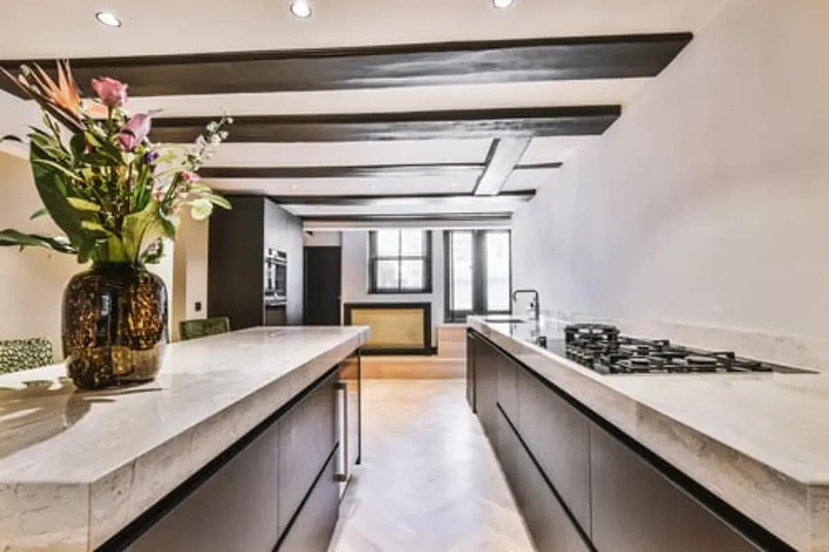 Open-plan kitchen with a large island and exposed beams