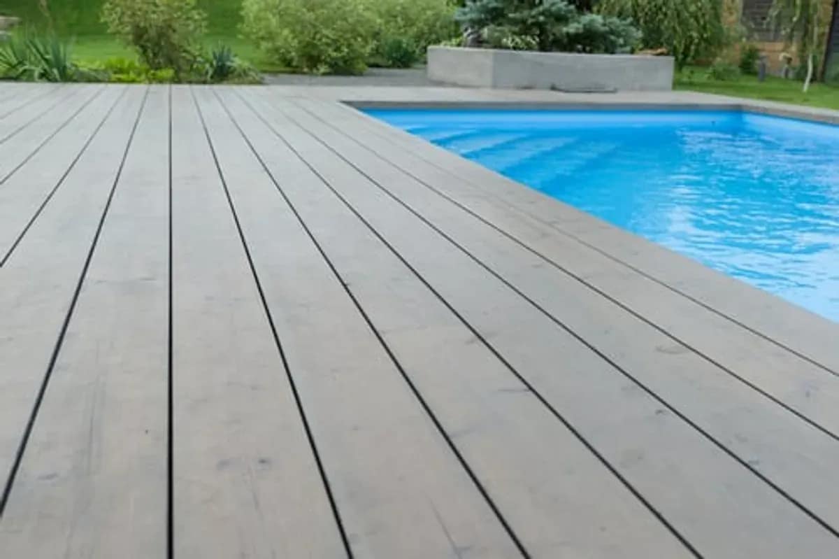 Composite deck boards installed beside a swimming pool