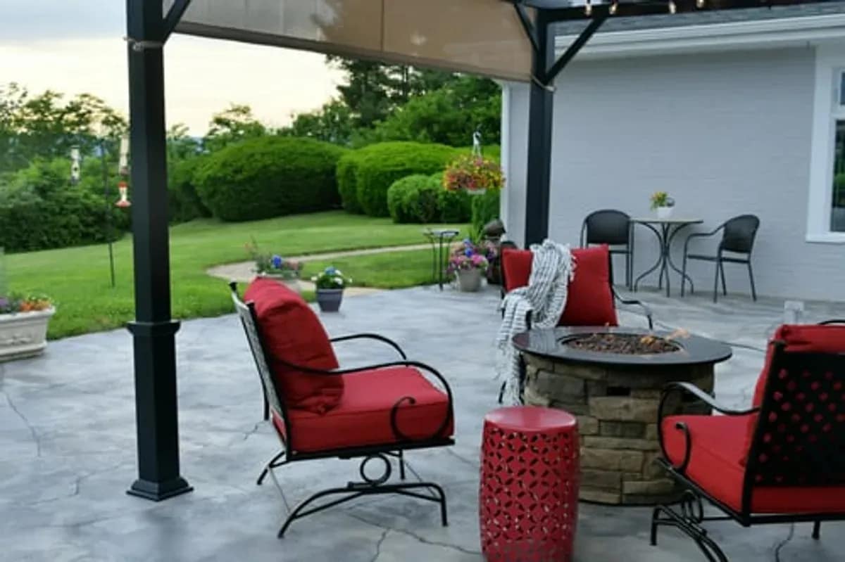 Finished concrete patio with outdoor seating behind a Maryland home