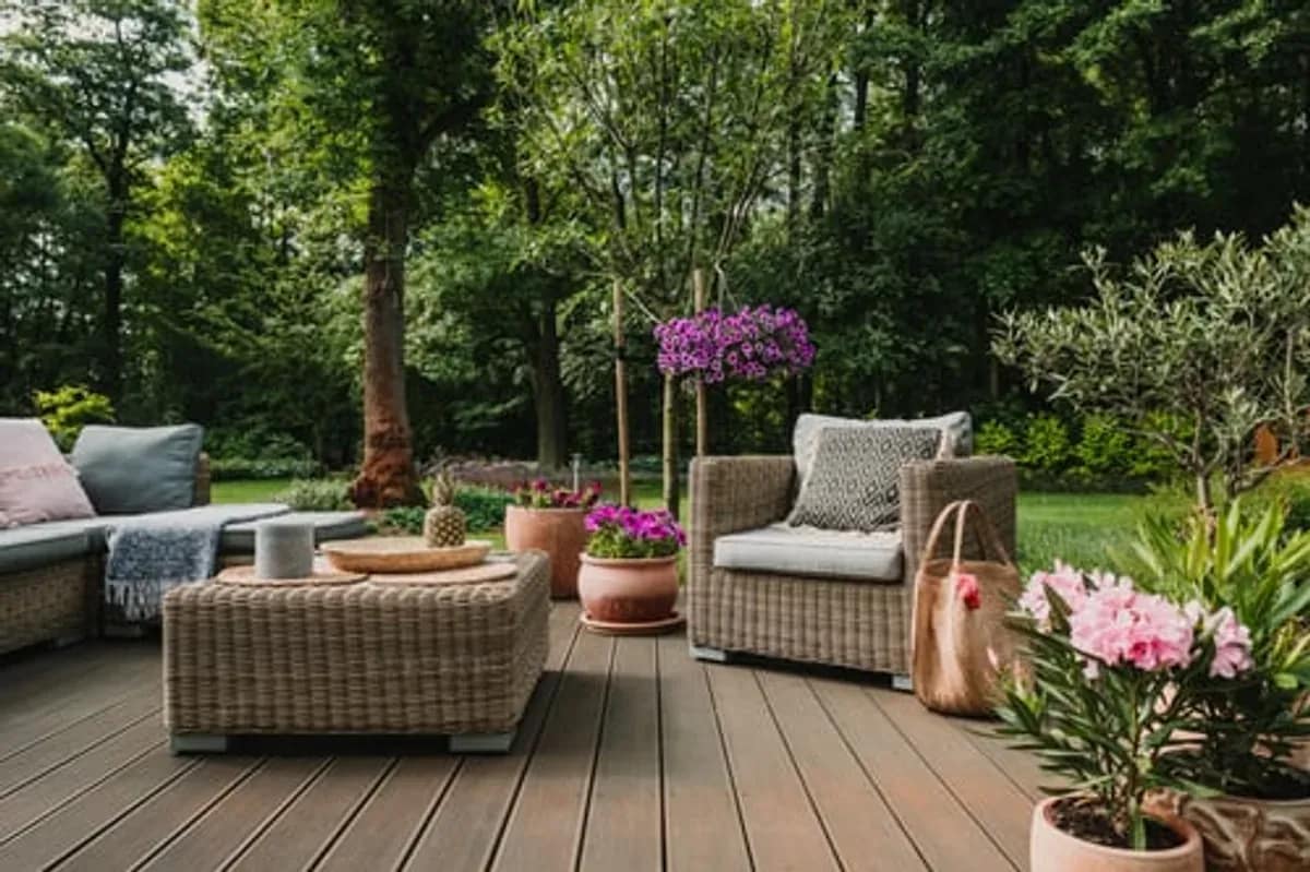 Newly built wood deck with outdoor furniture overlooking a landscaped yard
