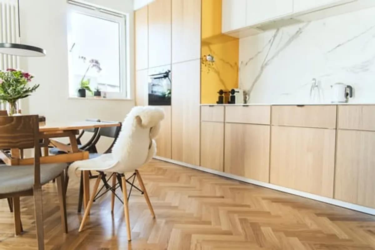 Newly installed hardwood flooring in a bright dining room