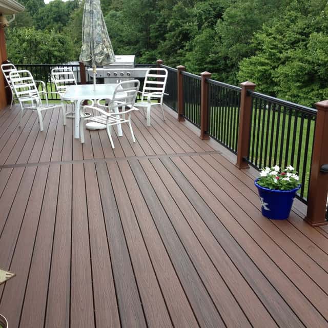 Composite deck with black aluminium railing and an outdoor dining set — Sky Property INC, Baltimore, MD