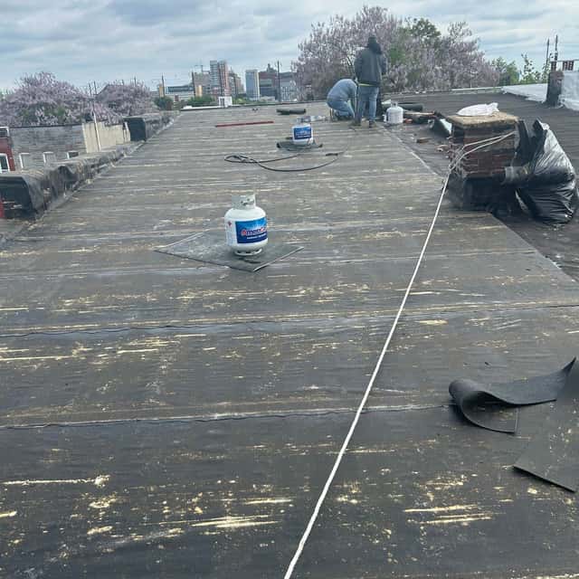 Flat roof with rolled roofing being installed — Sky Property INC, Baltimore, MD
