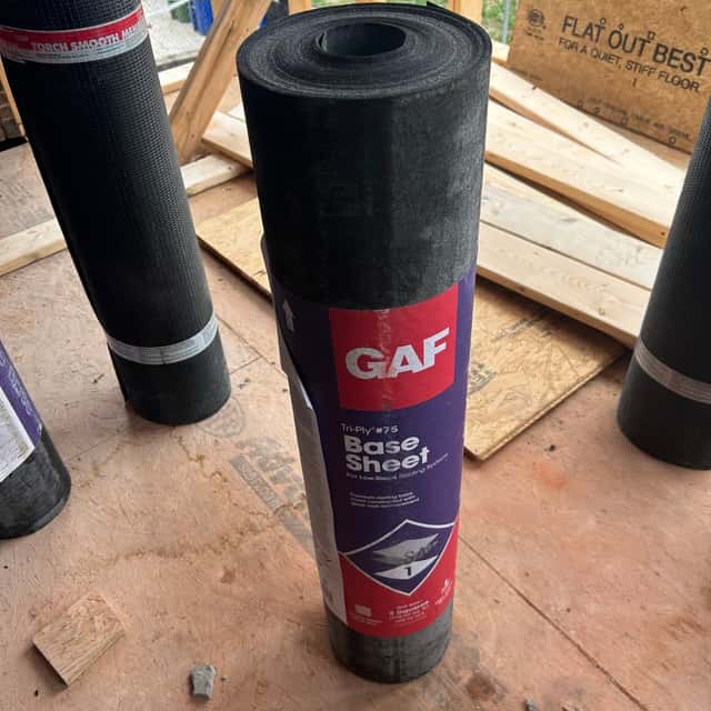 Rolls of GAF base sheet staged on a flat roof — Sky Property INC, Baltimore, MD