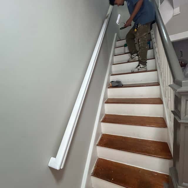 Refinished hardwood staircase with white risers and a new handrail — Sky Property INC, Baltimore, MD
