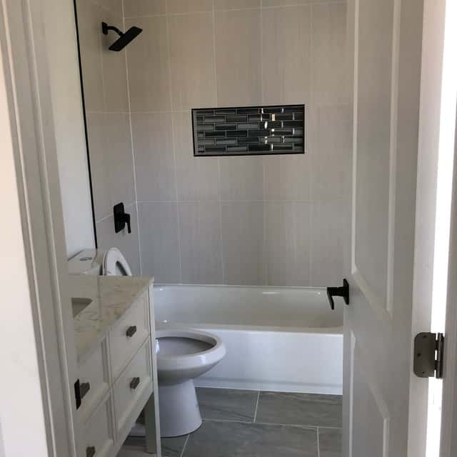 Bathroom remodel in progress with a tiled surround and new fixtures — Sky Property INC, Baltimore, MD