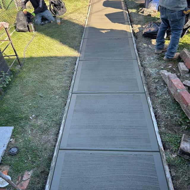 New concrete sidewalk poured beside a lawn — Sky Property INC, Baltimore, MD