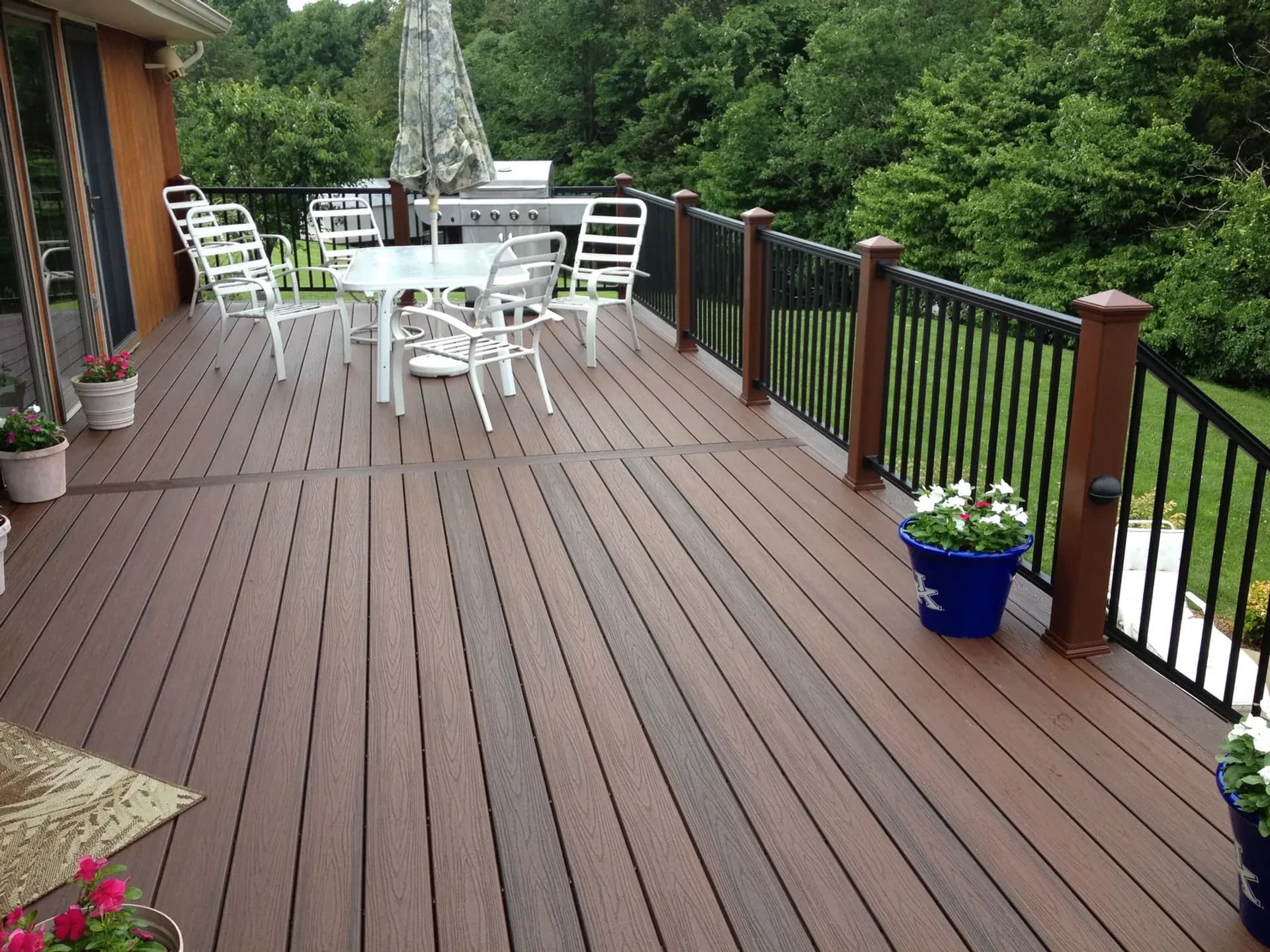 Finished composite deck with outdoor furniture built by Sky Property INC