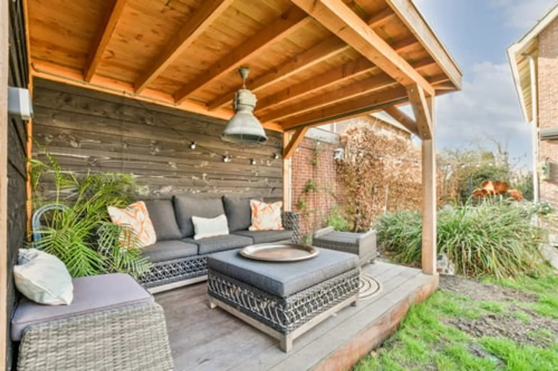 Covered outdoor living area with a fire pit and lounge seating