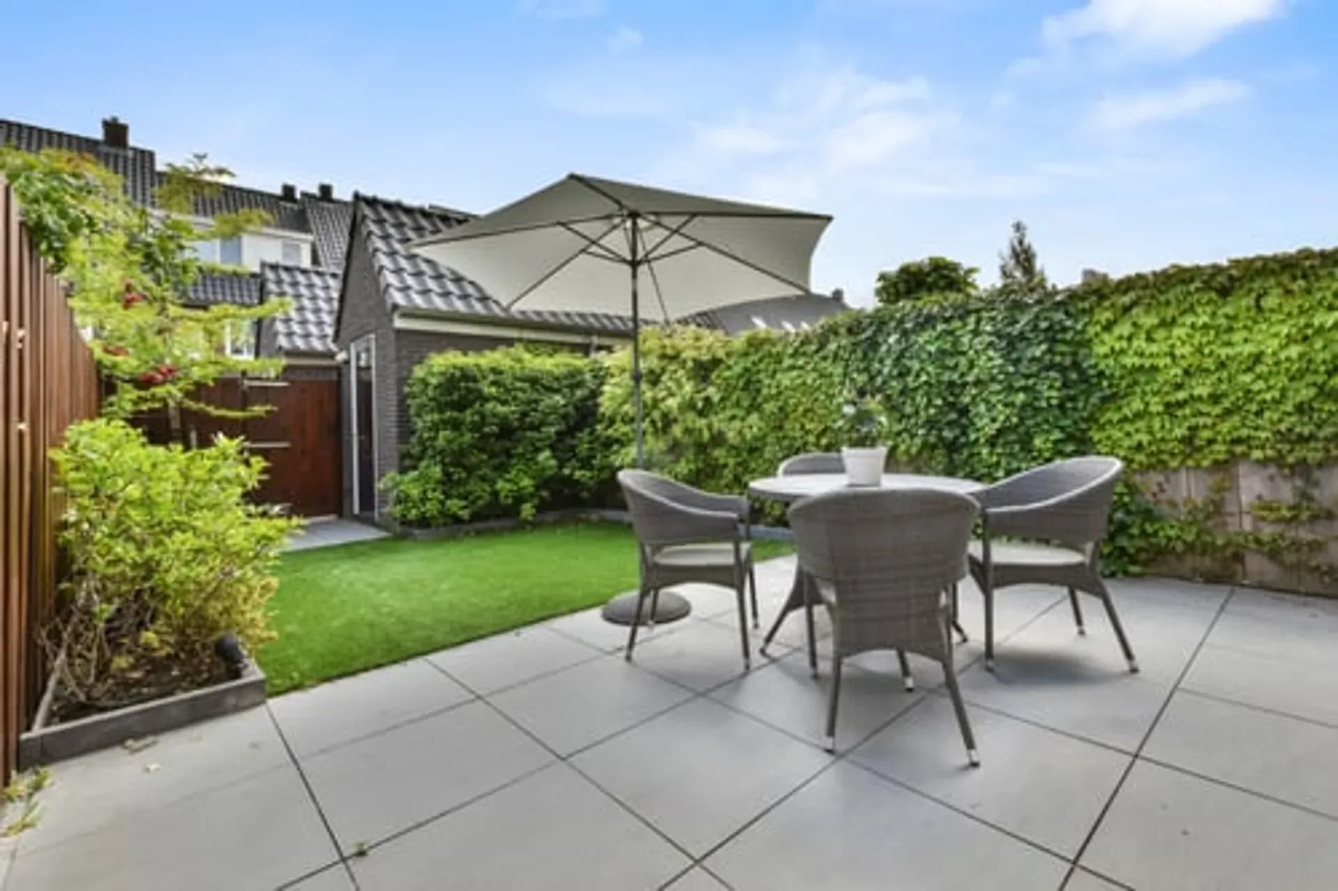 Covered outdoor living area with paver patio built by Sky Property INC