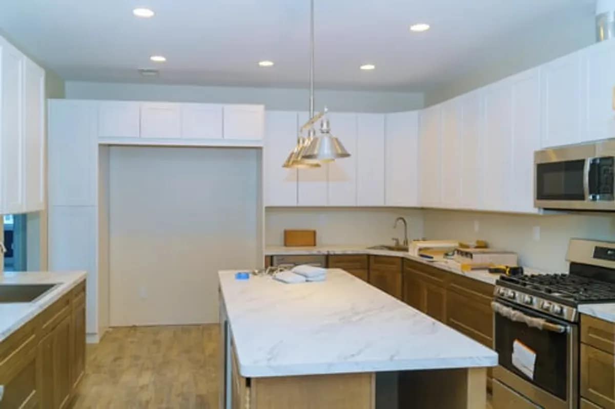 Remodeled kitchen with a stone island and pendant lighting